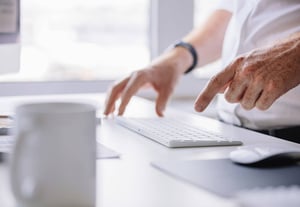 man typing on keyboard